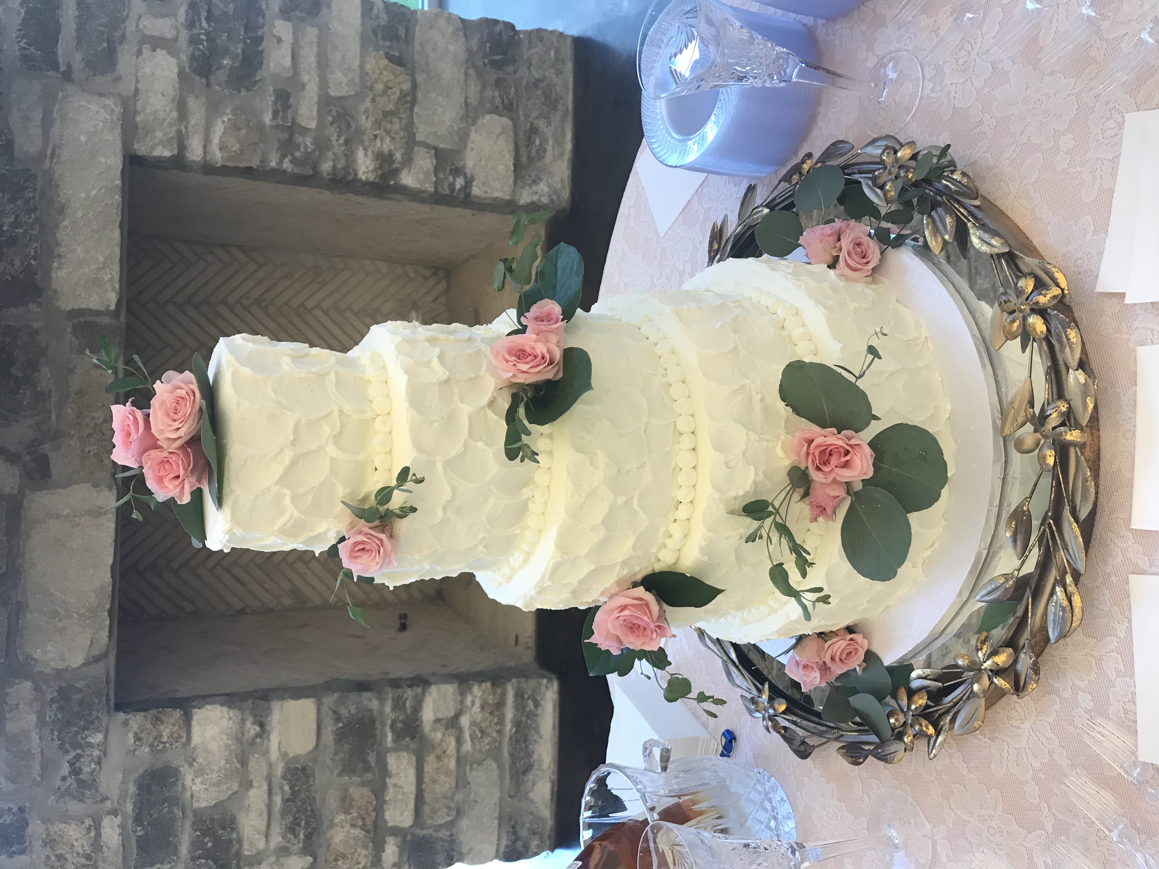 Textured buttercream tiers adorned with fresh pink roses